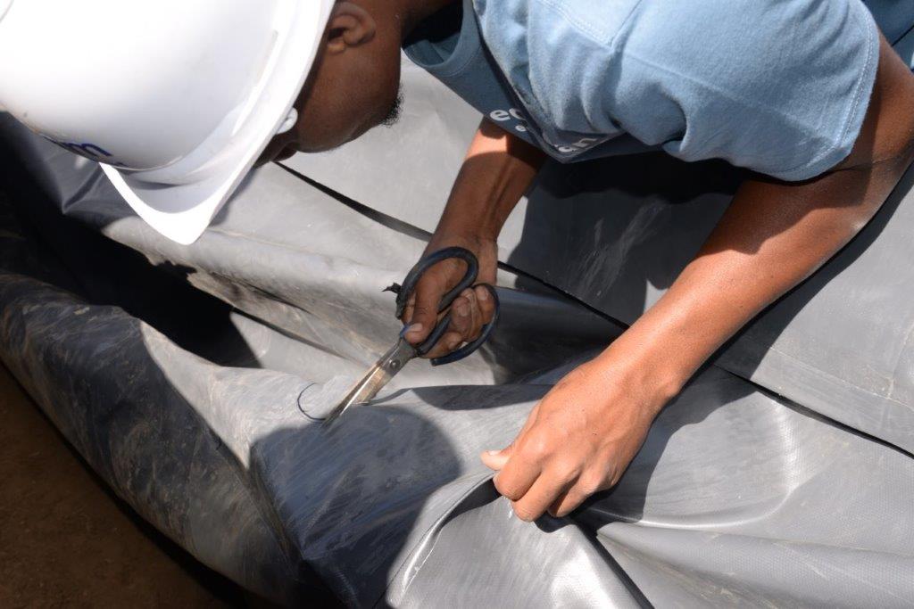 9. mark the spot on the pvc liner that aligns with the outlet hole, and cut out using a pair of scissors